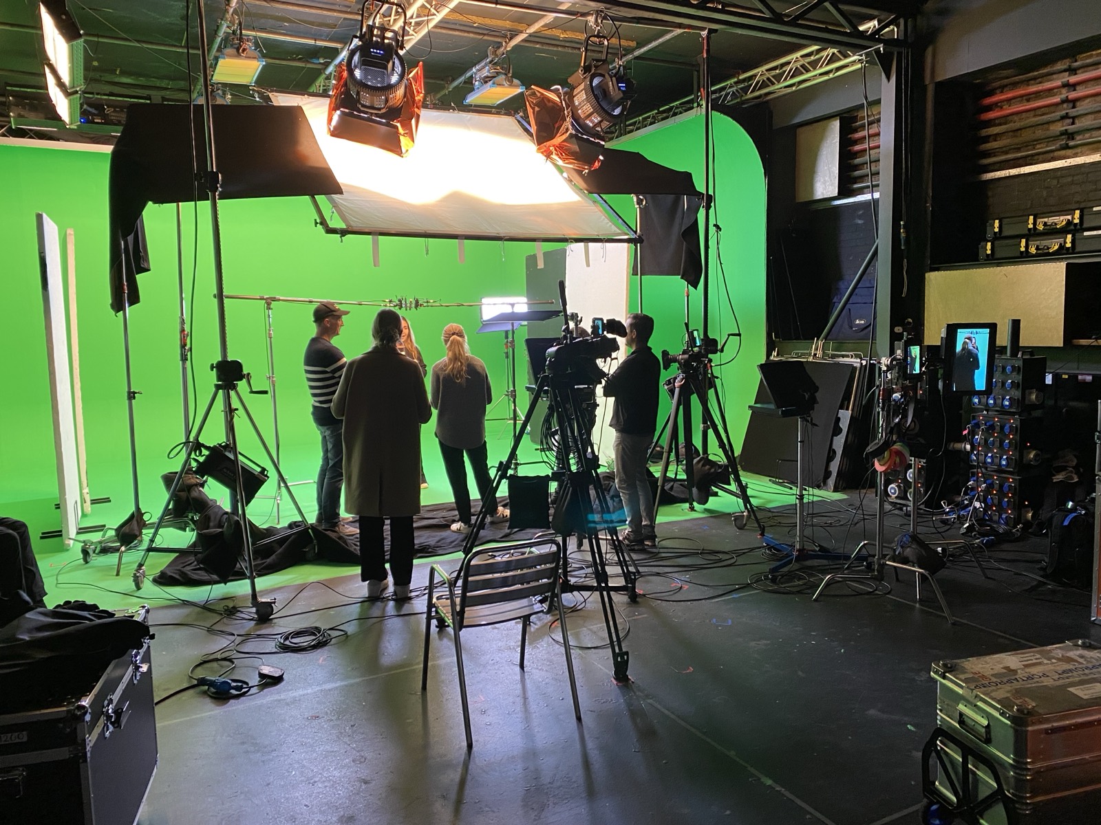 Camera operator silhouetted on a film set